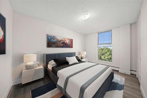 A bedroom with a large bed and a painting on the wall.