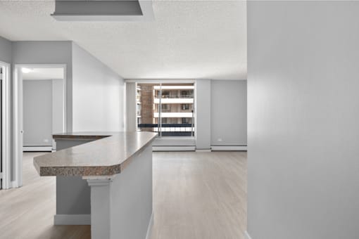 A kitchen with a granite countertop and a refrigerator.