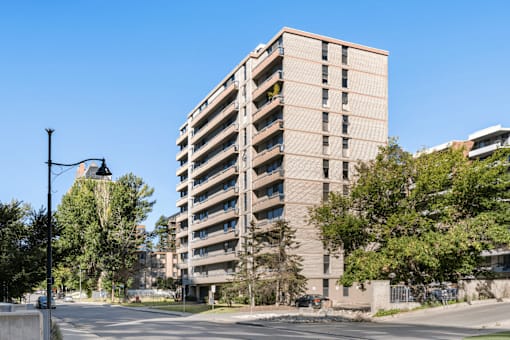 A tall building with a balcony on the 10th floor.