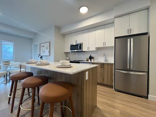A kitchen with a bar area and stools.