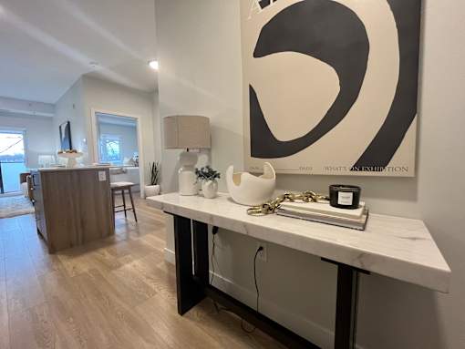 A modern kitchen with a large painting on the wall.