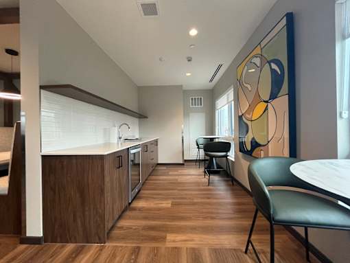 A modern kitchen with a dining table and chairs.