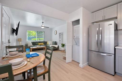 A modern kitchen with a dining table set for two.