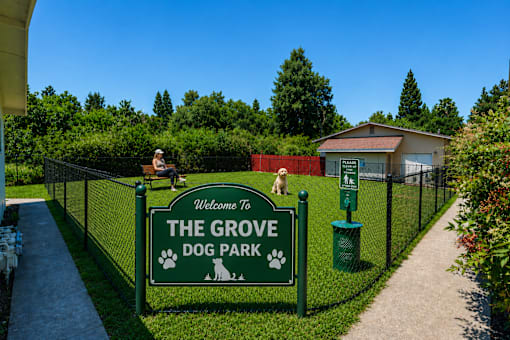 A sign welcoming visitors to The Grove Dog Park.