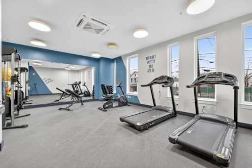 A gym with treadmills and other exercise equipment.