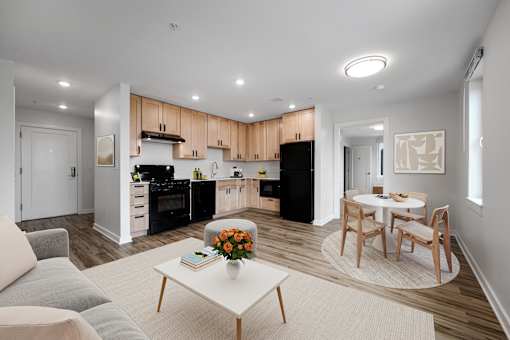 A modern kitchen with a dining table and chairs.