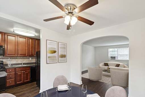 a living room with a ceiling fan and a dining table