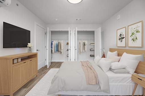 A bedroom with a bed, a dresser, and a mirror.