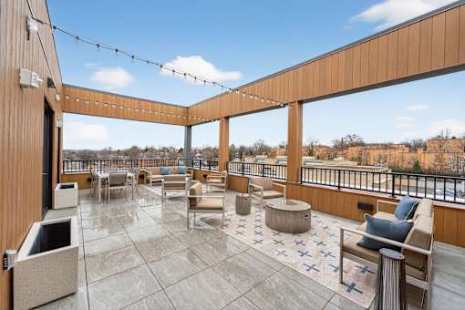 A balcony with a table and chairs and a view of the city.