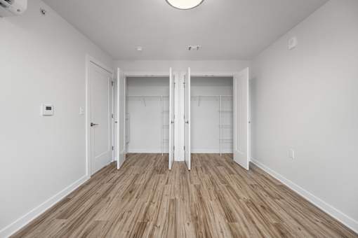 A room with a wooden floor and white walls.