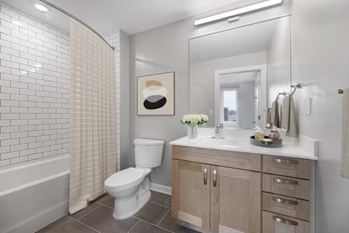 A white toilet sits in a bathroom next to a white sink.