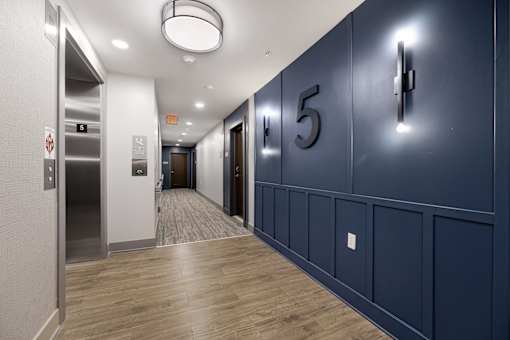 A hallway with a blue wall and a number 5 on it.