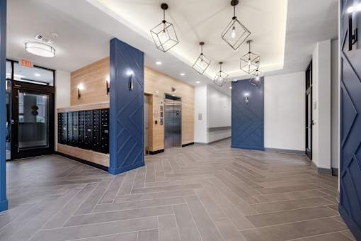 A modern kitchen with dark blue cabinets and a wooden counter.