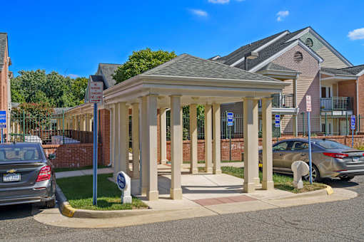 A small building with a porch and a sign that says "No Parking".