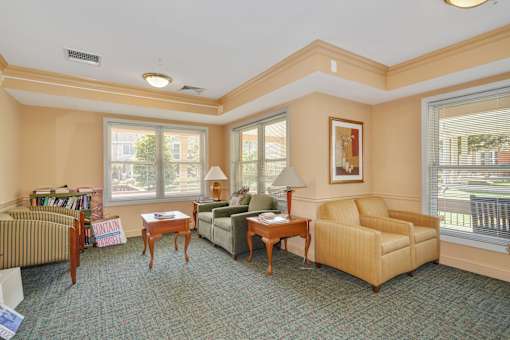 A living room with a sofa, armchair, and coffee table.