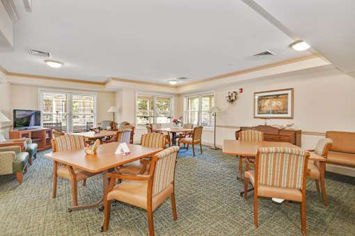 A room with a dining table and chairs.