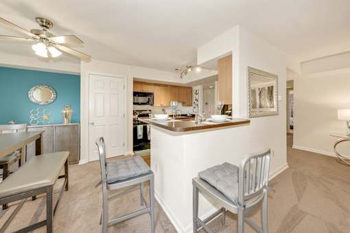A kitchen with a blue wall and a white counter.