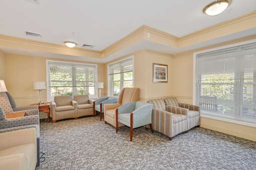 A living room with a striped couch and a wooden table.