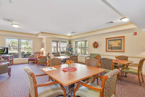 A dining room with a wooden table surrounded by chairs.