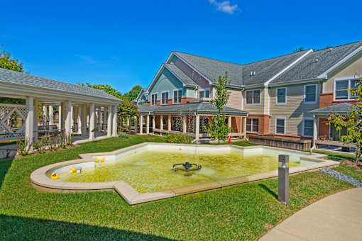 A backyard with a pool and a gazebo.