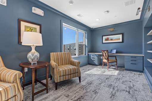 A room with blue walls and a striped chair.