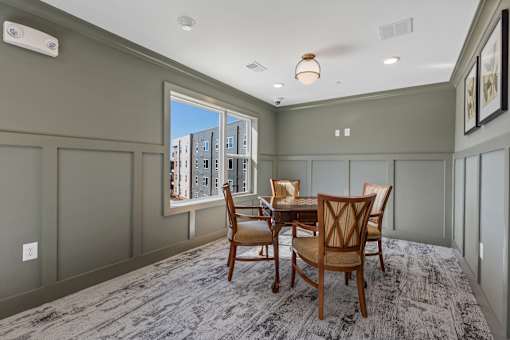 A dining room with a table set for four.