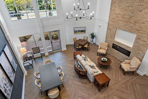 A living room with a brick wall and a fireplace.