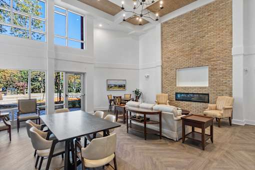A living room with a brick wall and a fireplace.