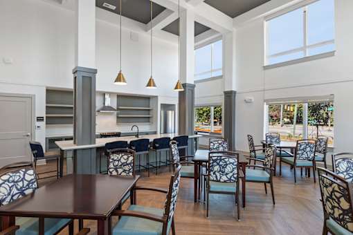 A modern dining room with a long table and chairs.