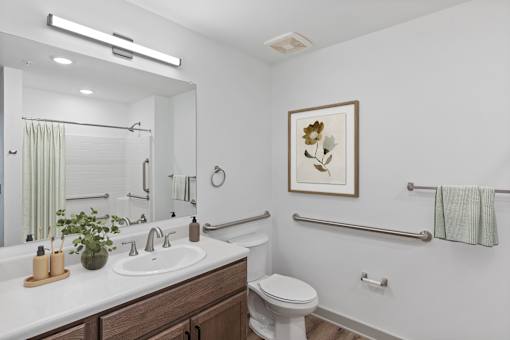 A bathroom with a white toilet and a white sink.