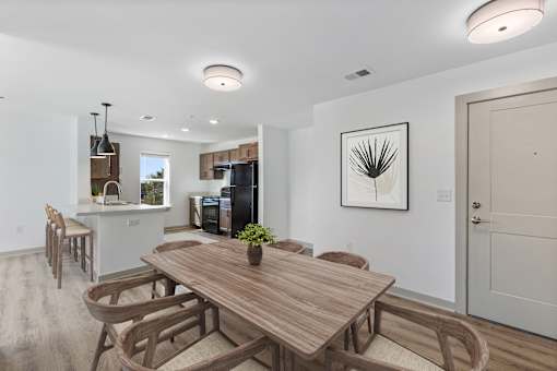 A modern dining room with a wooden table and chairs.