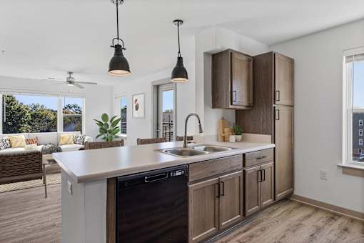 A modern kitchen with a large island and wooden cabinets.