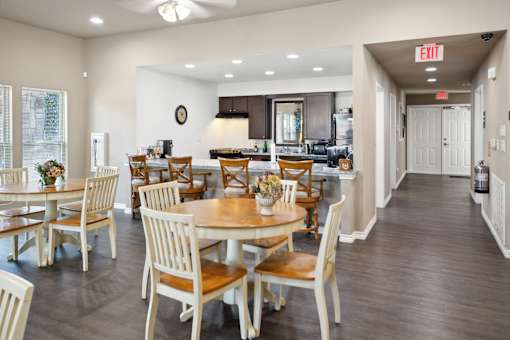 A dining room with a table set for six.