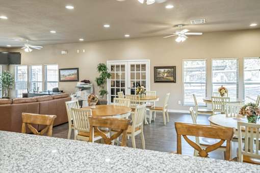 A dining room with a table set for six.
