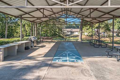 A shaded outdoor area with a blue painted line in the middle.
