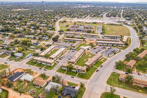 A bird's eye view of a residential area with apartment buildings and houses.