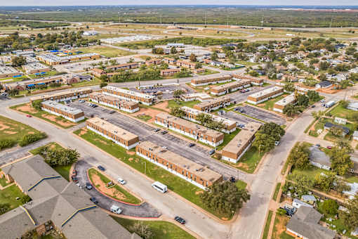 A bird's eye view of a residential area with houses and roads.