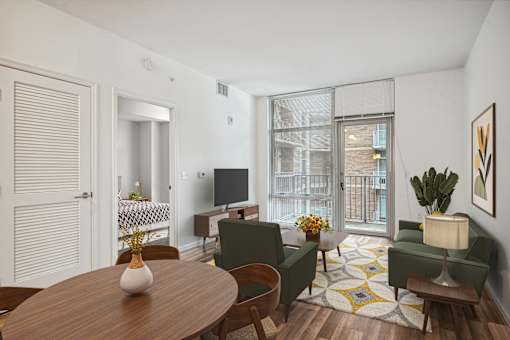 a living room with a table and chairs and a tv