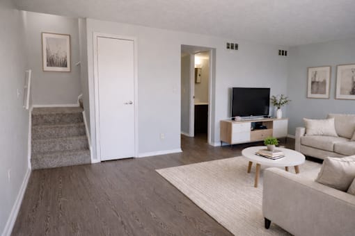 A living room with a couch, coffee table, and television.