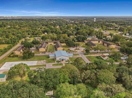 A bird's eye view of a campus with a large building in the center.