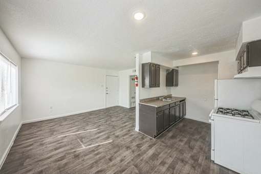 A kitchen area with a white fridge, a microwave, and a countertop.
