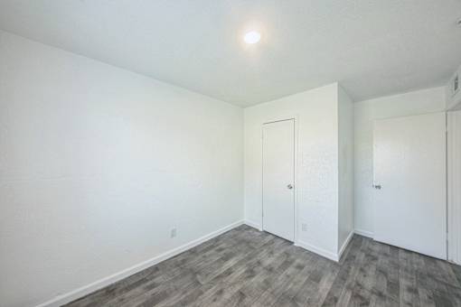 A room with a wooden floor and white walls.
