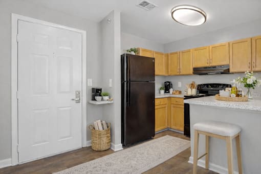 A kitchen with a refrigerator, stove, and oven.