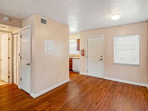 A room with wooden floors and white doors.