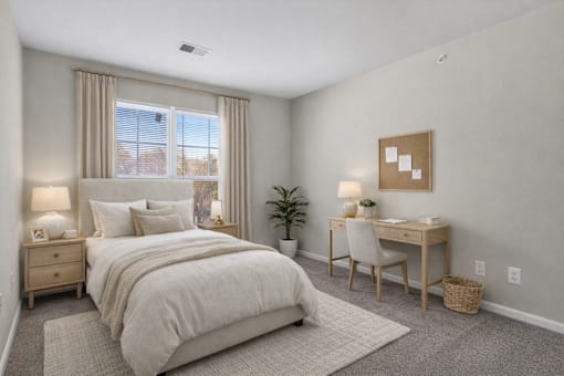 A bedroom with a large bed, desk, and chair.