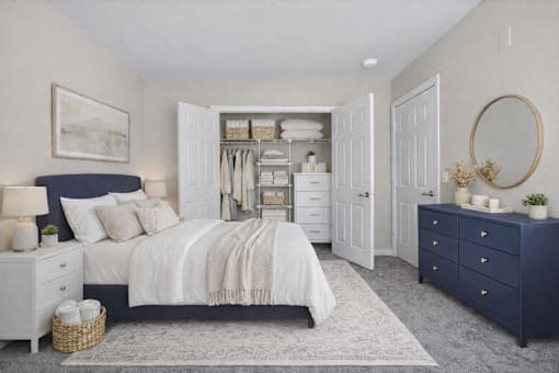 A bedroom with a large bed, a dresser, and a mirror.
