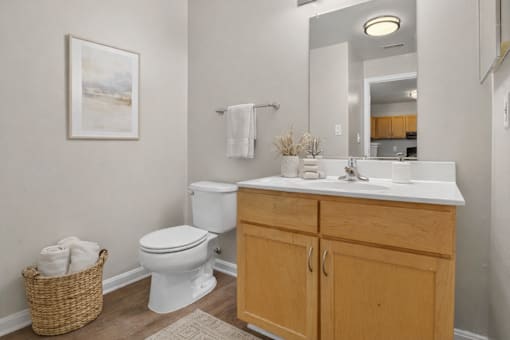 A white toilet sits next to a white sink in a bathroom.