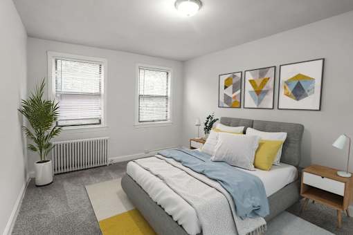 A bedroom with a bed, nightstand, and a potted plant.