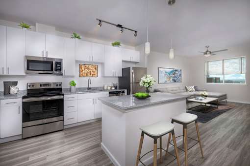A modern kitchen with white cabinets and a large island.