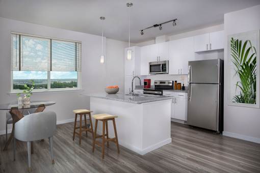A modern kitchen with a dining table and chairs.